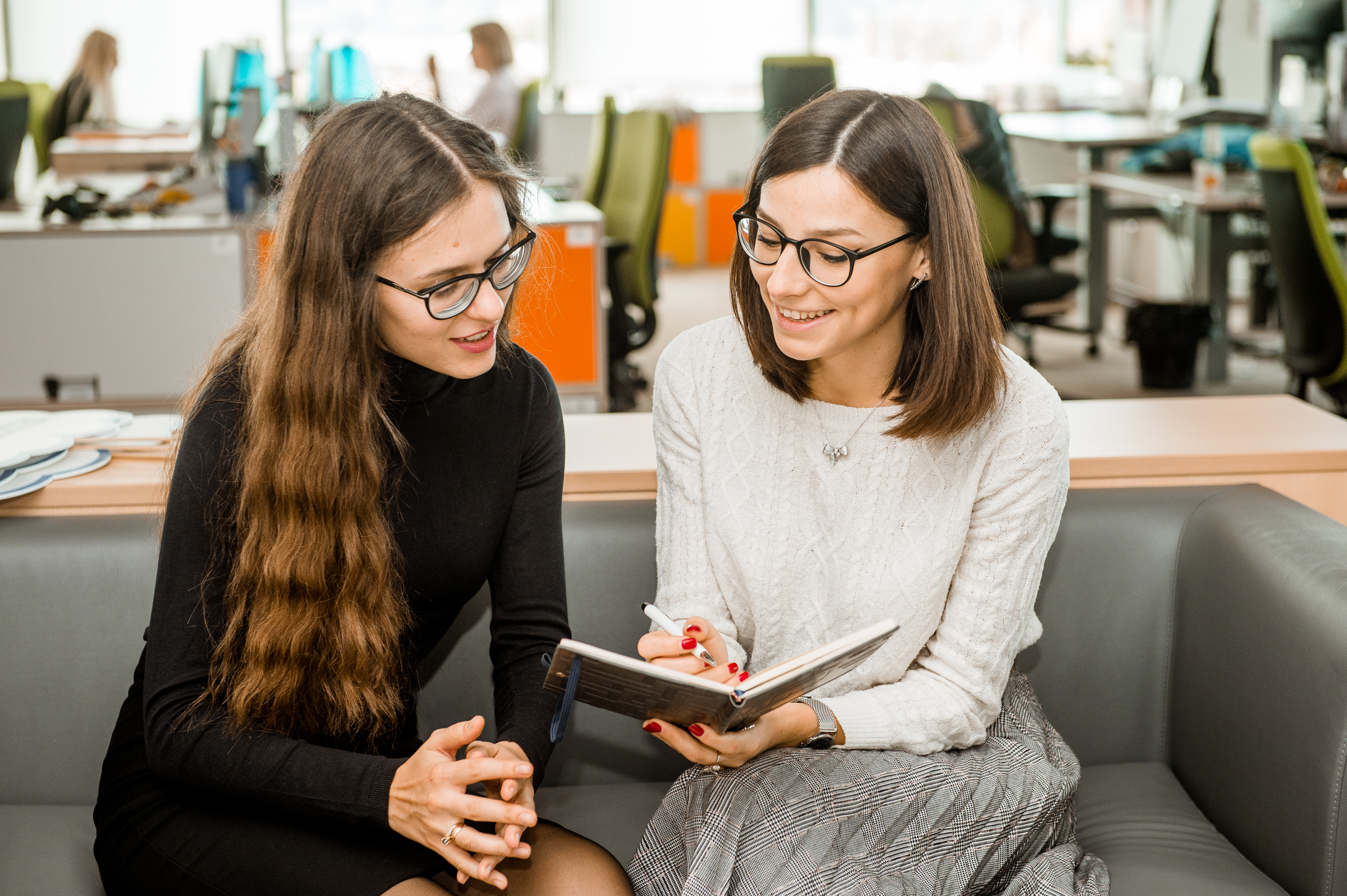 Two Women discussing notes