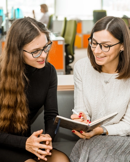 Two Women discussing notes